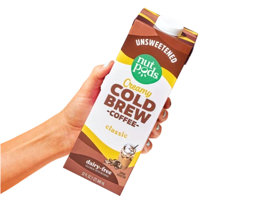 a hand holding a bottle of nutpods Classic Creamy Cold Brew