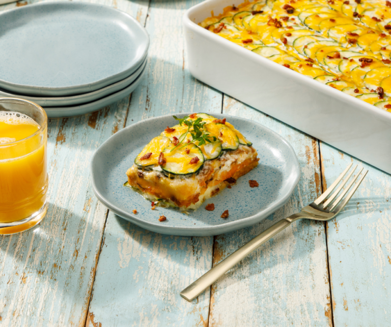 BACON CHEDDAR SCALLOPED ZUCCHINI on a plate next to a fork