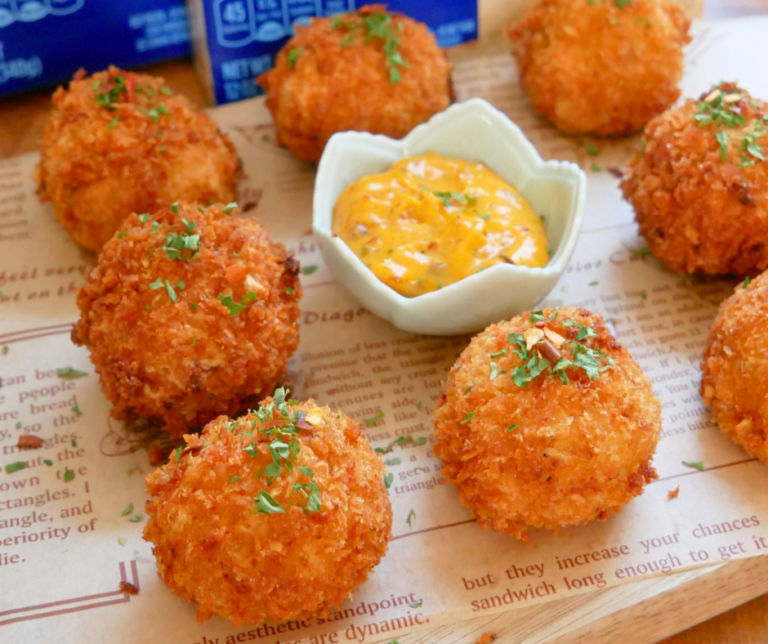 Crispy Cheesy Mashed Cauliflower Balls with a bowl of sauce in the middle