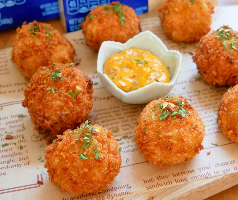 Crispy Cheesy Mashed Cauliflower Balls with a bowl of sauce in the middle
