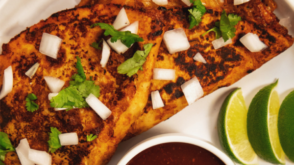 close up of two tacos on a plate