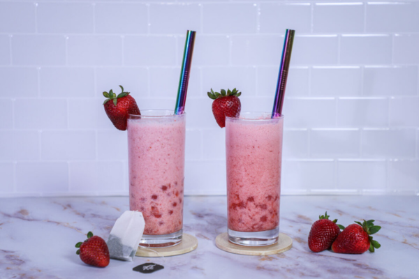Head on shot of two clear glasses with strawberry lemonade boba inside