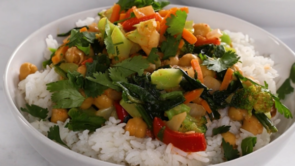 A white bowl filled with rice and vegetable curry