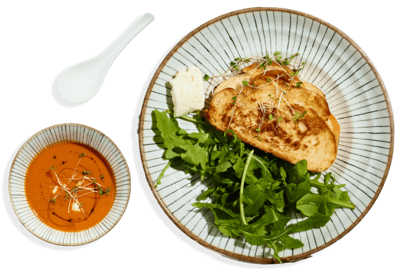a meal consisting of soup, bread, and spinach